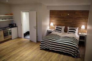 a bedroom with a bed with a wooden headboard at Thoristun Apartments in Selfoss