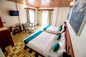 Postel nebo postele na pokoji v ubytování Sunbird Garden Resort