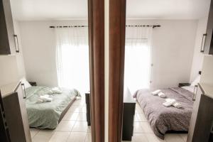 A bed or beds in a room at Meteora's Secret Garden House#2
