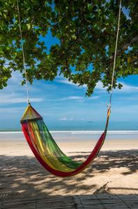 a colorful hammock hanging from a tree on the beach at Klongdao Sunset Villa in Ko Lanta