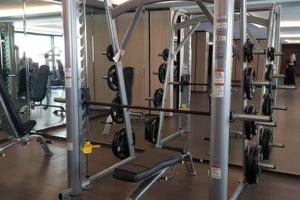 a gym with lots of equipment in a room at Luxury 2 BR Condo at Casa Grande Residence - Kasablanka Mall in Jakarta