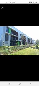 a picture of a large building with a grass field at lovely 1 bedroom apartment in Ballito