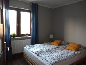Posteľ alebo postele v izbe v ubytovaní Dom Mazurska Apartamenty