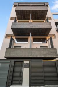 an external view of a building with black shutters at ATHENIAN VIEW LOFT in Athens