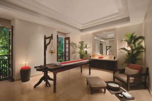 a living room with a pool table and a chair at Grand Hyatt Goa in Bambolim