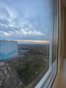 a view of a city from a window of a building at Замечательная евродвушка район Теремков 209 in Teremki