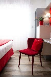 מיטה או מיטות בחדר ב-Colmar Hotel