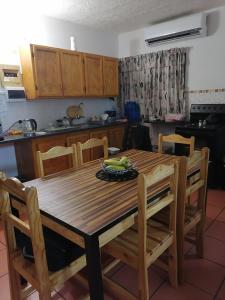 a kitchen with a wooden table with bananas on it at St Lucia Villa Mia 6 in St Lucia
