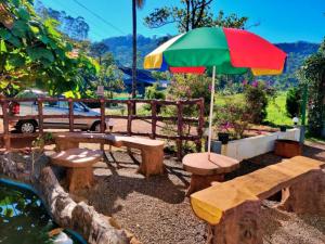 a group of benches and an umbrella at Wild Mist Homestay in Munnar