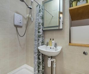 a bathroom with a sink and a shower at Meadow view Stay - Drymen in Drymen
