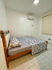 a small bedroom with a bed in a room at Vale Hospedar Paulo Coelho Apart in Petrolina