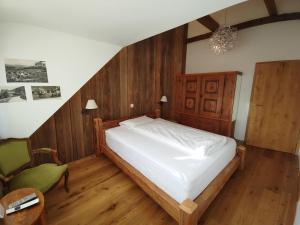 Landgasthof Roderis في Nunningen: غرفة نوم بسرير وكرسي أخضر