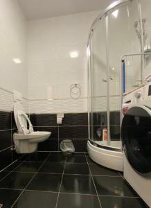 a bathroom with a shower and a toilet and a sink at Apartman 2 Old Bridge view in Mostar +17 photos