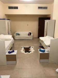 a room with two beds and a room with a room with a bed at Kaya Hostel in Dubai