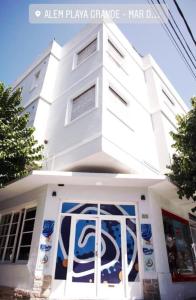 a white building with a mural on the front of it at Hostel Playa Grande Austral in Mar del Plata