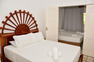 En eller flere senge i et værelse på Pousada da Divisa