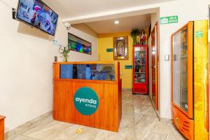 a shop with a kiosk and a tv in a room at Ayenda Onix Suite in Pasto