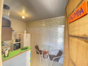 a kitchen with two chairs and a counter top at FLAT BAÍA DO SANCHO in Fernando de Noronha