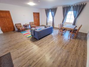a living room with a blue couch and chairs at Apartment in Herrenhaus Groß Pinnow in Groß Pinnow