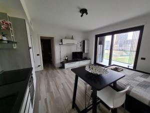 a kitchen with a small table and a kitchen with a window at Grazioso Monolocale Milano in Milan