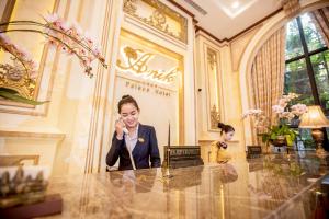 Anik Palace Hotel في بنوم بنه: امرأة تتحدث على الهاتف الخلوي في الردهة