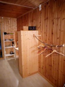 a room with a wooden wall with a tree on it at Guesthouse Simolle in Hammarstrand