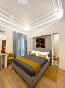 a bedroom with a large bed in a room at ERASMO 19 Luxury Home in Catania