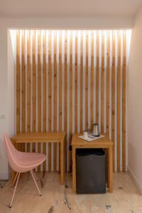 a room with a wooden wall with a desk and a chair at Hotel Boutique Sibarys - Adults Recommended in Nerja