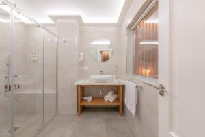 a bathroom with a sink and a shower at Hotel Boutique Sibarys - Adults Recommended in Nerja