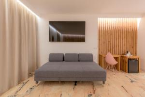 a bedroom with a bed and a television on the wall at Hotel Boutique Sibarys - Adults Recommended in Nerja