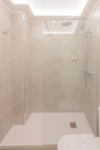 a shower with a glass door in a bathroom at Hotel Boutique Sibarys - Adults Recommended in Nerja