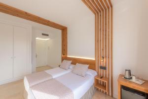 a bedroom with a bed and a mirror at Hotel Boutique Sibarys - Adults Recommended in Nerja