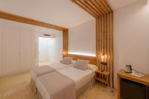 a bedroom with a bed and a television in it at Hotel Boutique Sibarys - Adults Recommended in Nerja