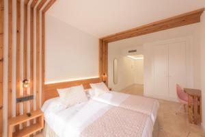 a bedroom with a bed and a desk and a table at Hotel Boutique Sibarys - Adults Recommended in Nerja