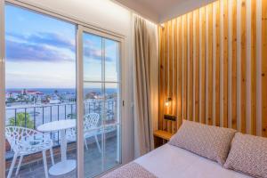 a bedroom with a bed and a balcony with a view at Hotel Boutique Sibarys - Adults Recommended in Nerja