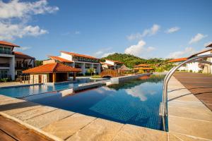 a swimming pool in front of a building at Club Meridional Praia dos Carneiros - Perto da Igrejinha in Praia dos Carneiros