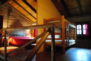 a bedroom with two bunk beds in a building at CABAÑAS LA ARBOLEDA DE TOMASA in Villa Rumipal