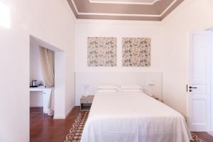 Postel nebo postele na pokoji v ubytování Riflessi Acireale Palace Suites