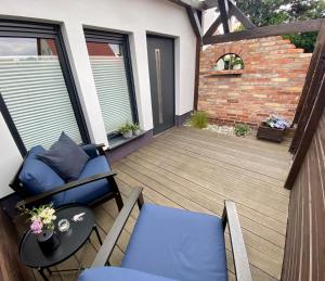 a patio with chairs and a table on a deck at Appartement Sterne in Senftenberg