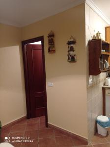 a kitchen with a red door and a kitchen floor at Casa Carrasco in Algar