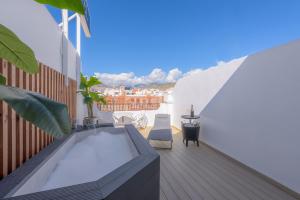 a balcony with a hot tub on a building at Hotel Boutique Sibarys - Adults Recommended in Nerja