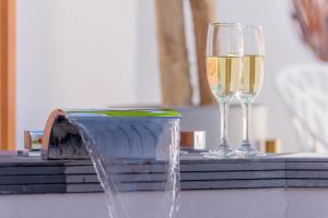 two glasses of white wine sitting on a table at Hotel Boutique Sibarys - Adults Recommended in Nerja
