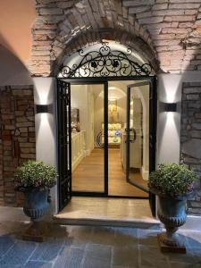 an open door with two potted plants in a room at Antica Dimora Desenzano in Desenzano del Garda