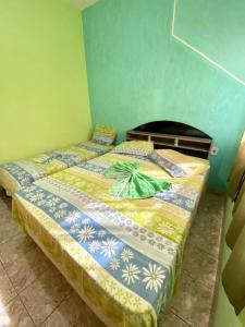 Een bed of bedden in een kamer bij Casa de Temporada Ubirajara
