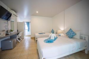 a hotel room with two beds and a kitchen at Assava Dive Resort - SHA Plus in Ko Tao