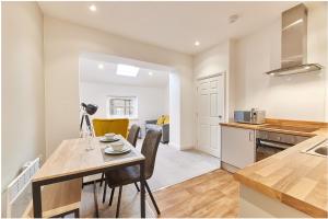 a kitchen and dining room with a table and chairs at Barnes boutique apartment in Sunderland