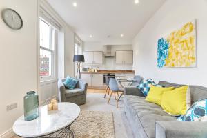 a living room with a couch and a table at Herrington boutique apartment in Sunderland