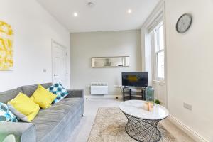 a living room with a couch and a table at Herrington boutique apartment in Sunderland