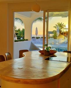 a dining room table with a view of the ocean at VILLA8 in Puerto de Santiago