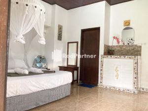 Postel nebo postele na pokoji v ubytování Taman Ayu Homestay Munduk Mitra RedDoorz